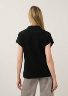 Back view of black ribbed top with high collar showcasing seamless design by French Dressing Jeans (FDJ)