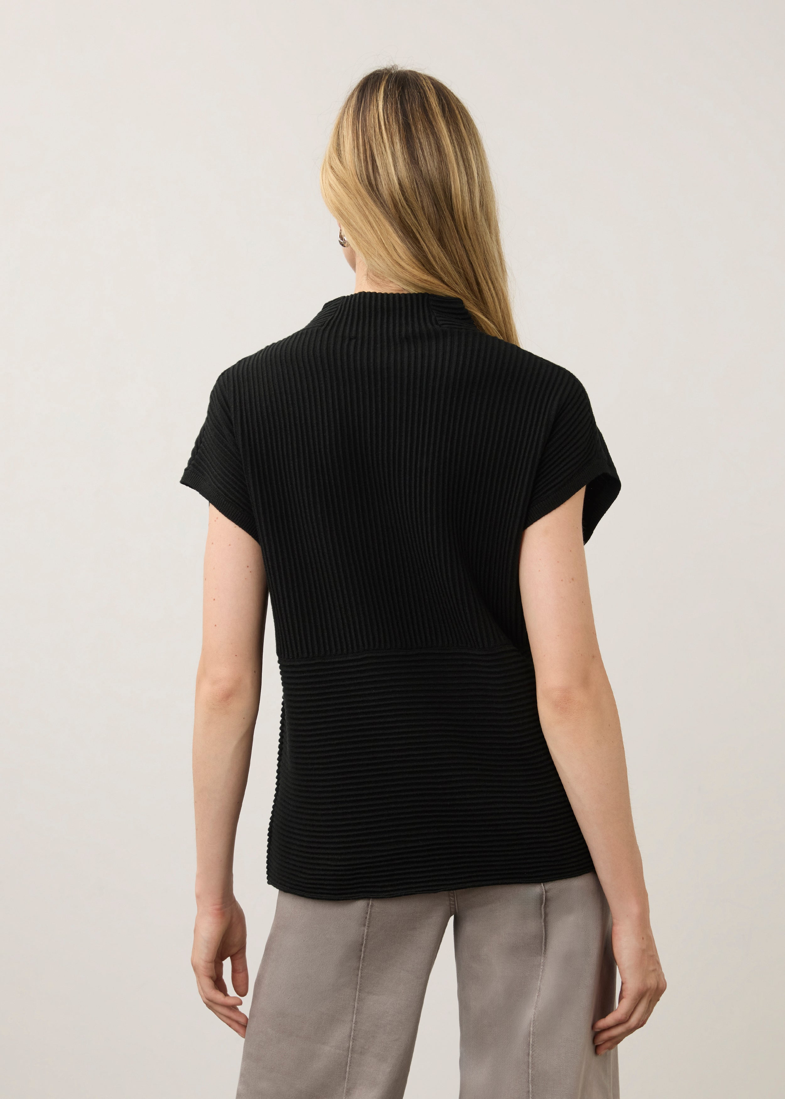 Back view of black ribbed top with high collar showcasing seamless design by French Dressing Jeans (FDJ)