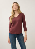 Front view of burgundy 3/4 sleeve V-neck top highlighting rich color and smooth fabric by French Dressing Jeans (FDJ)