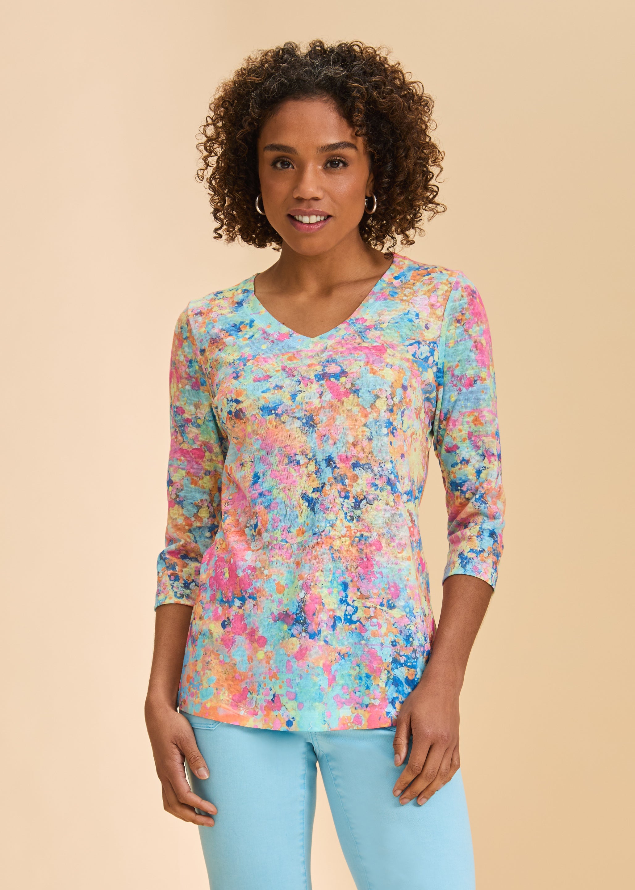 Front view of colorful abstract print 3/4 sleeve V-neck top paired with blue jeans by French Dressing Jeans (FDJ)