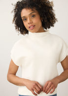 Close-up of white ribbed top showing high collar and short sleeves by French Dressing Jeans (FDJ)