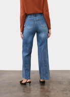 Back view of indigo jeans showing patch pockets and straight leg silhouette by French Dressing Jeans (FDJ)