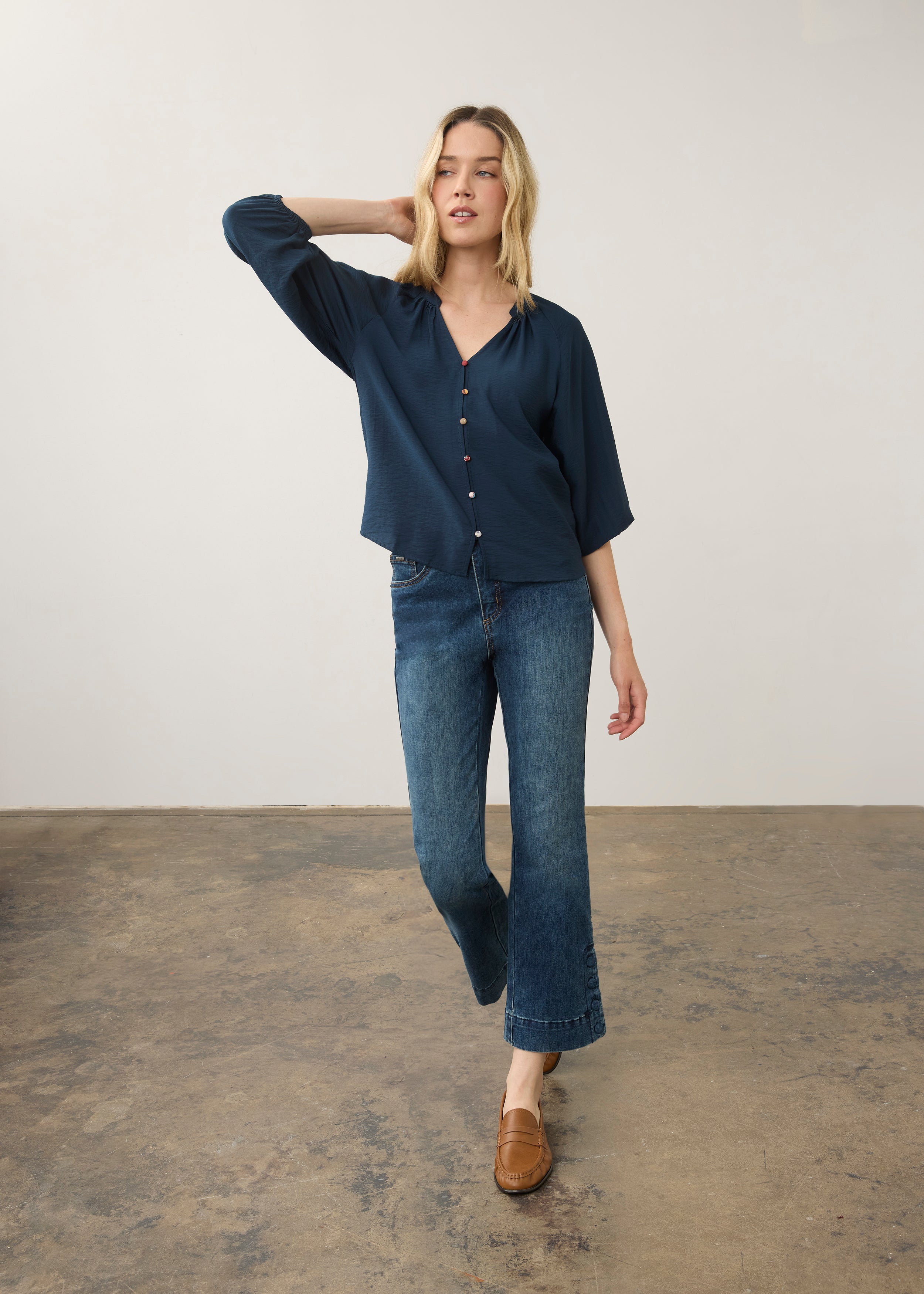Model in navy blouse and jeans, full body view by French Dressing Jeans (FDJ)