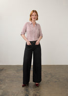 Model in striped red and white shirt and black pants, full body view by French Dressing Jeans (FDJ)
