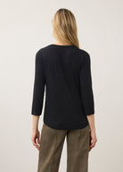 Back view of black V-neck top showing seamless design and smooth texture by French Dressing Jeans (FDJ)