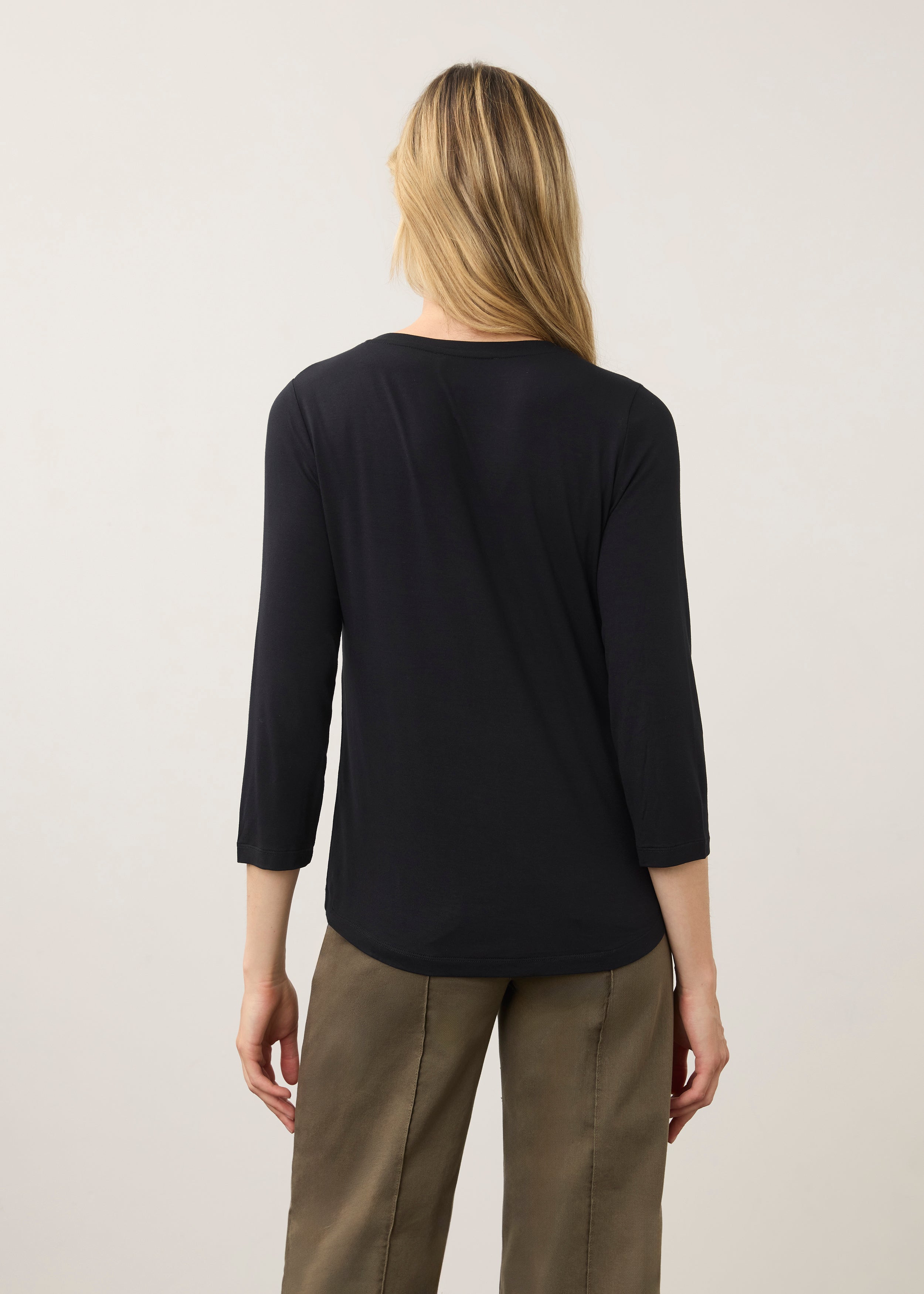 Back view of black V-neck top showing seamless design and smooth texture by French Dressing Jeans (FDJ)