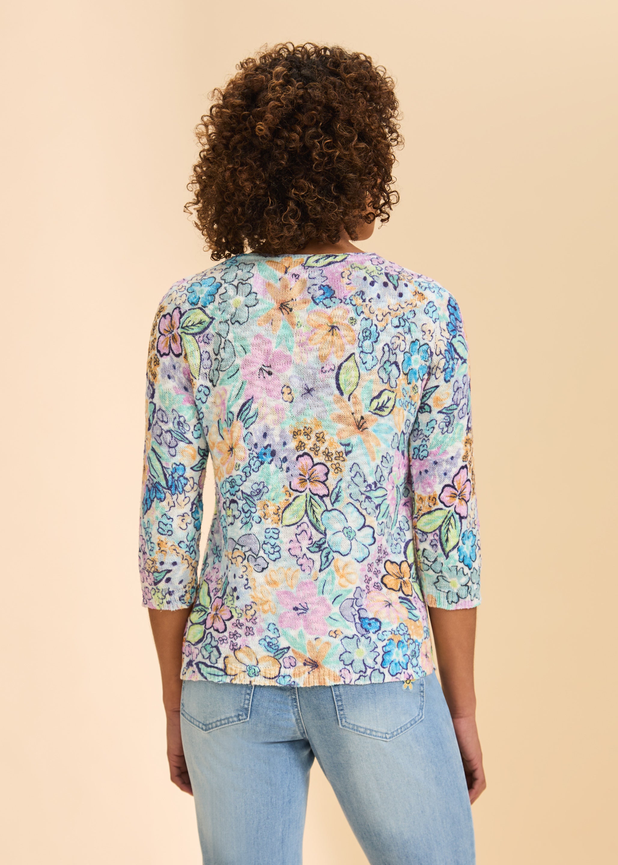 Back view of pastel floral print sweater highlighting vivid pattern by French Dressing Jeans (FDJ)