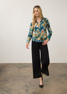 Model in blue floral shirt and black pants, full body view by French Dressing Jeans (FDJ)