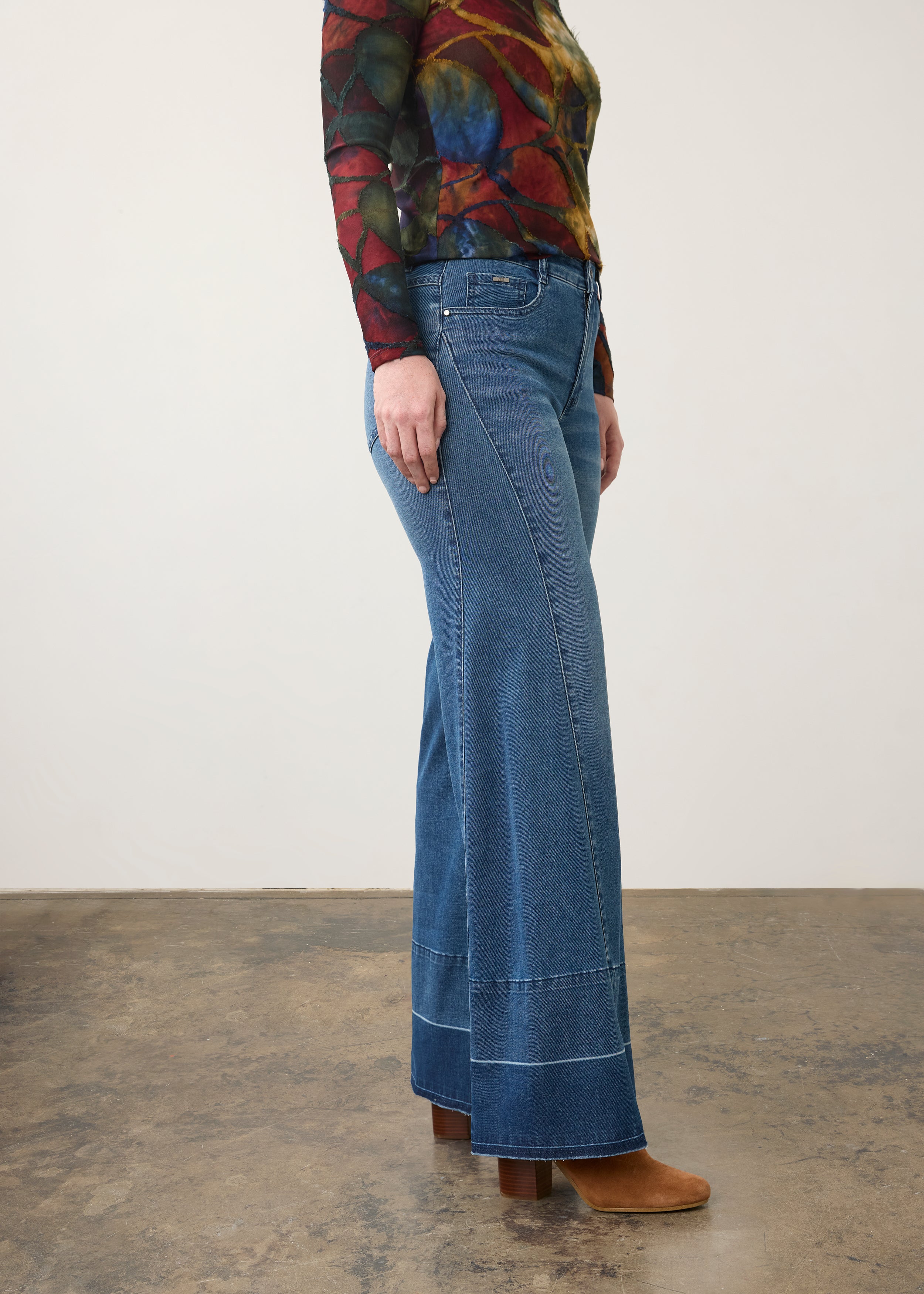 Side view of wide-leg dark wash jeans with artistic top, highlighting leg silhouette by French Dressing Jeans (FDJ) par French Dressing Jeans (FDJ)