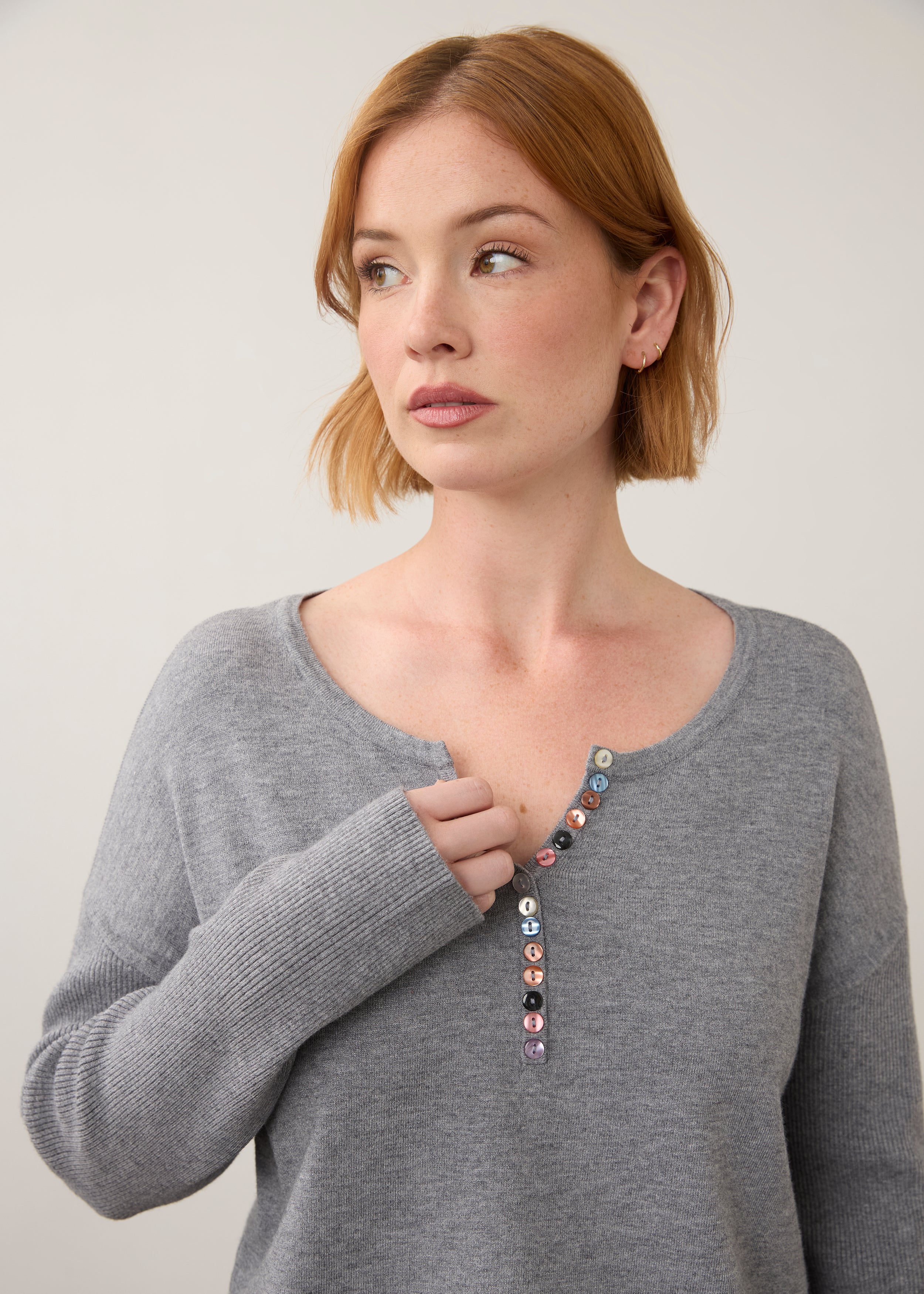 Close-up of grey sweater focusing on button details by French Dressing Jeans (FDJ)