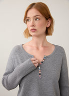 Close-up of grey sweater focusing on button details by French Dressing Jeans (FDJ)
