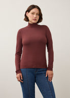 Front view of burgundy long sleeve turtleneck top with rich color and sleek fit by French Dressing Jeans (FDJ)
