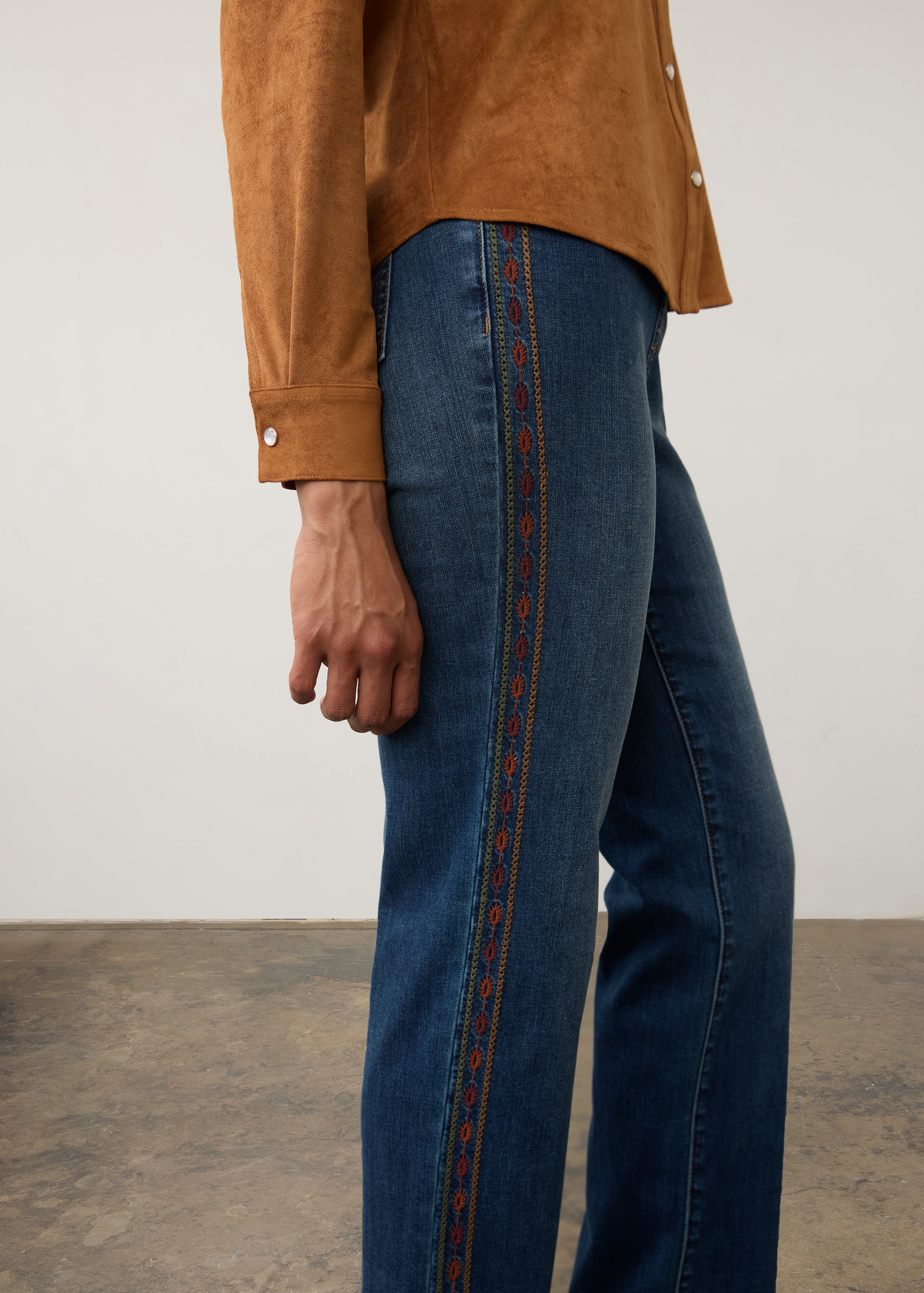 Side detail of medium blue jeans with decorative embroidery along the seam by French Dressing Jeans (FDJ) par French Dressing Jeans (FDJ)