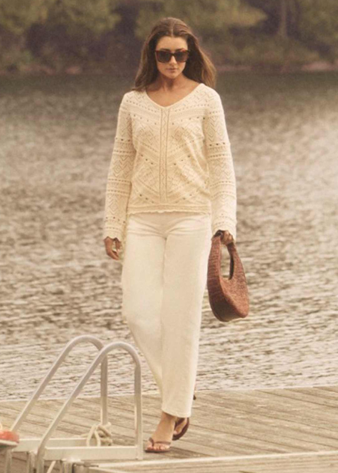 Outdoor view of woman in white sweater and pants on dock by French Dressing Jeans (FDJ)