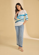Full view of white wave-patterned top with jeans, chic casual style by French Dressing Jeans (FDJ)