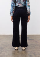 Back view of black wide leg pants featuring patch pockets and wide leg design by French Dressing Jeans (FDJ)