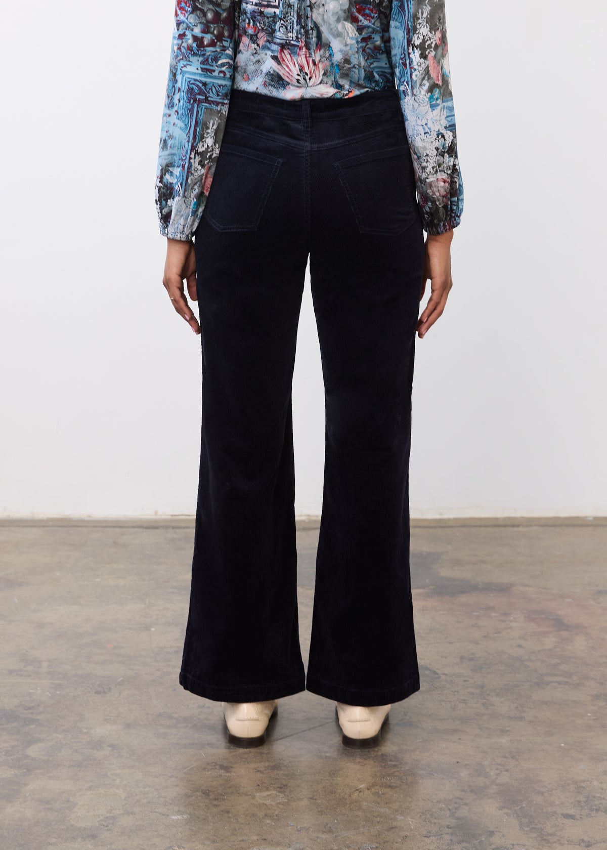 Back view of black wide leg pants featuring patch pockets and wide leg design by French Dressing Jeans (FDJ)