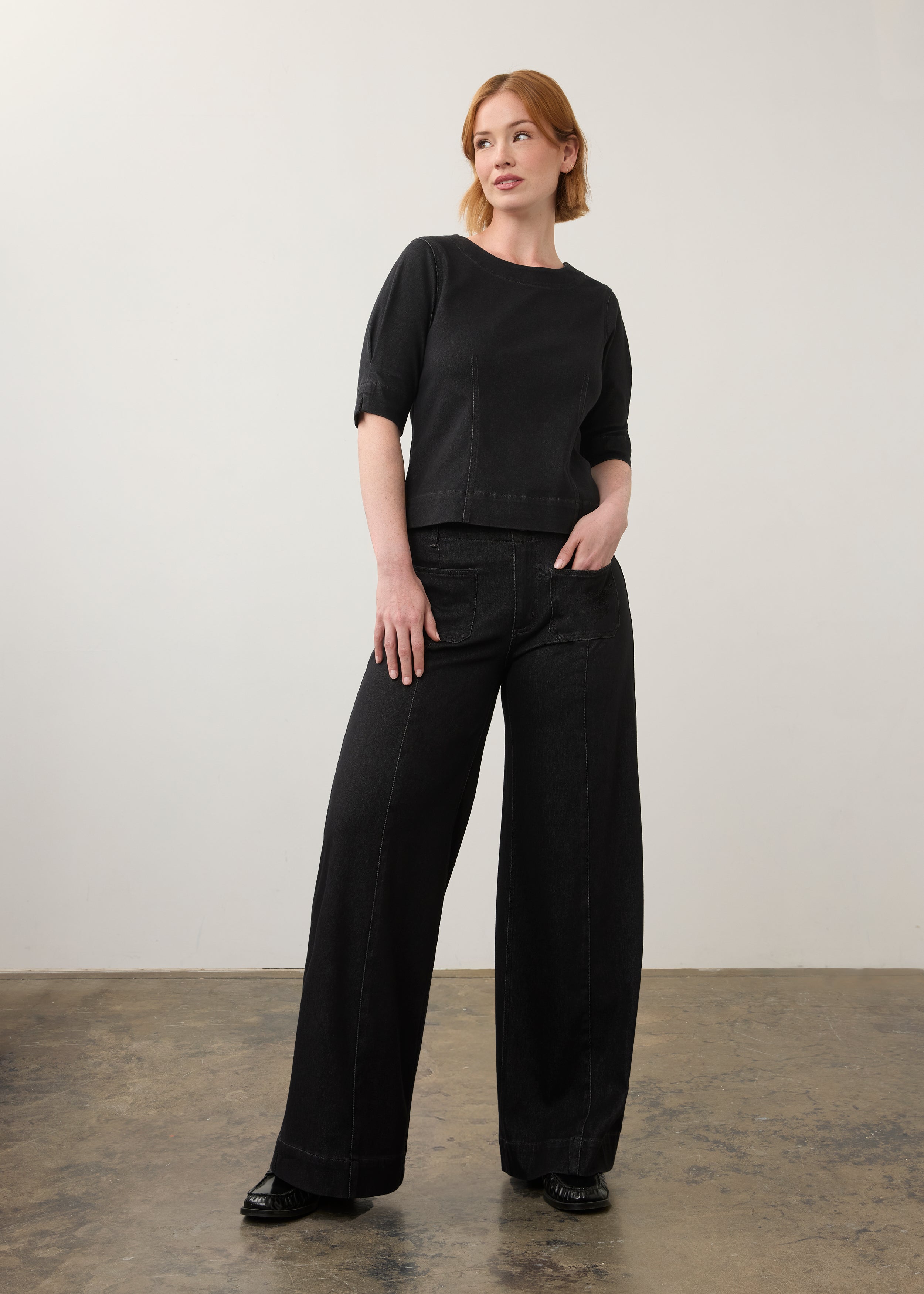 Full outfit view of black fitted top with matching wide-leg jeans by French Dressing Jeans (FDJ)