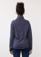Back view of navy sweater highlighting rounded hemline by French Dressing Jeans (FDJ)