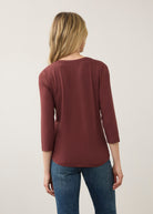 Back view of burgundy V-neck top with understated design and seamless back by French Dressing Jeans (FDJ)