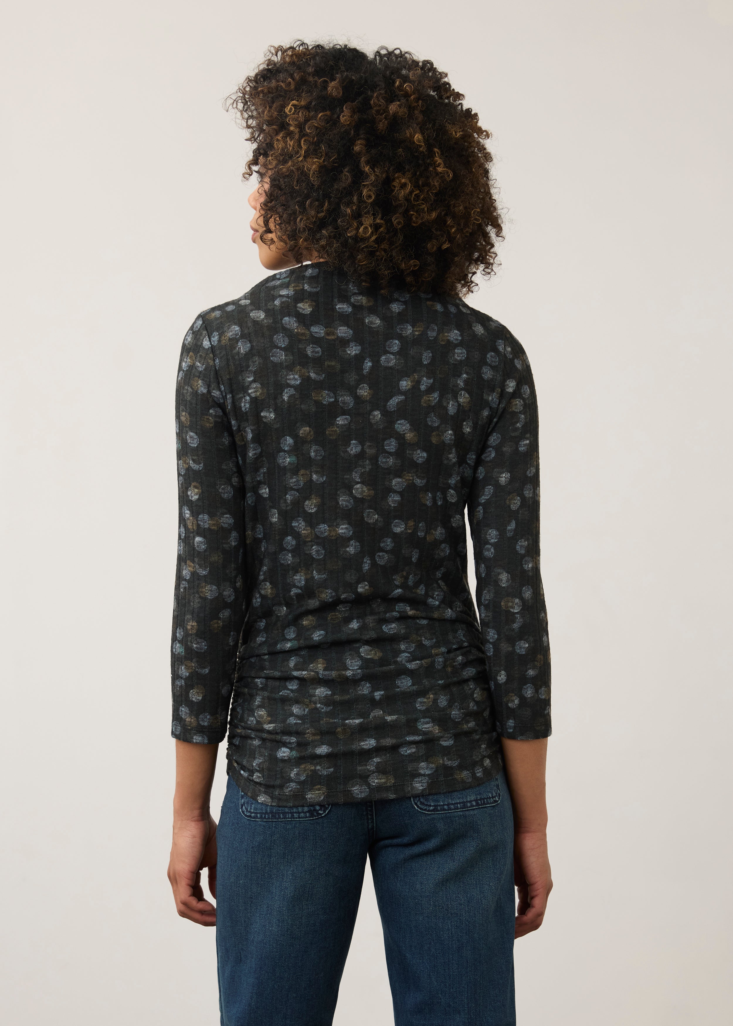Back view of black polka dot top, highlighting the seamless design and fit by French Dressing Jeans (FDJ)