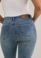 Close-up detail of back pocket stitching and FDJ label on light wash jeans by French Dressing Jeans (FDJ)