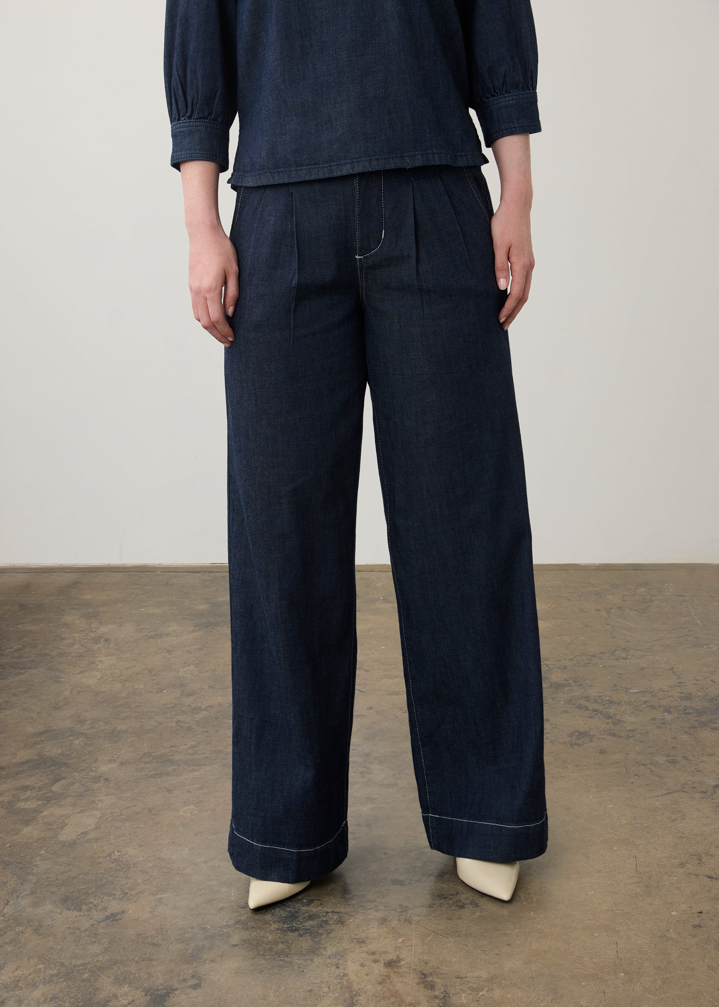 Close-up of dark wash wide-leg pants with pleats and a cropped denim top by French Dressing Jeans (FDJ)