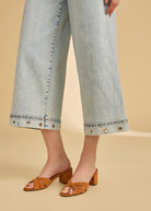 Side detail of ocean denim wide crop jeans with eyelet accents by French Dressing Jeans (FDJ)