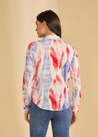 Back view of colorful long sleeve blouse showcasing bold pattern and curved hem, by French Dressing Jeans (FDJ)