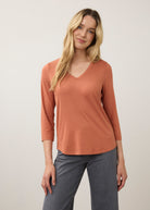 Front view of orange 3/4 sleeve V-neck top with warm tones and relaxed fit by French Dressing Jeans (FDJ)