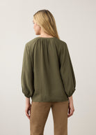 Back view of olive blouse highlighting puff sleeves by French Dressing Jeans (FDJ)