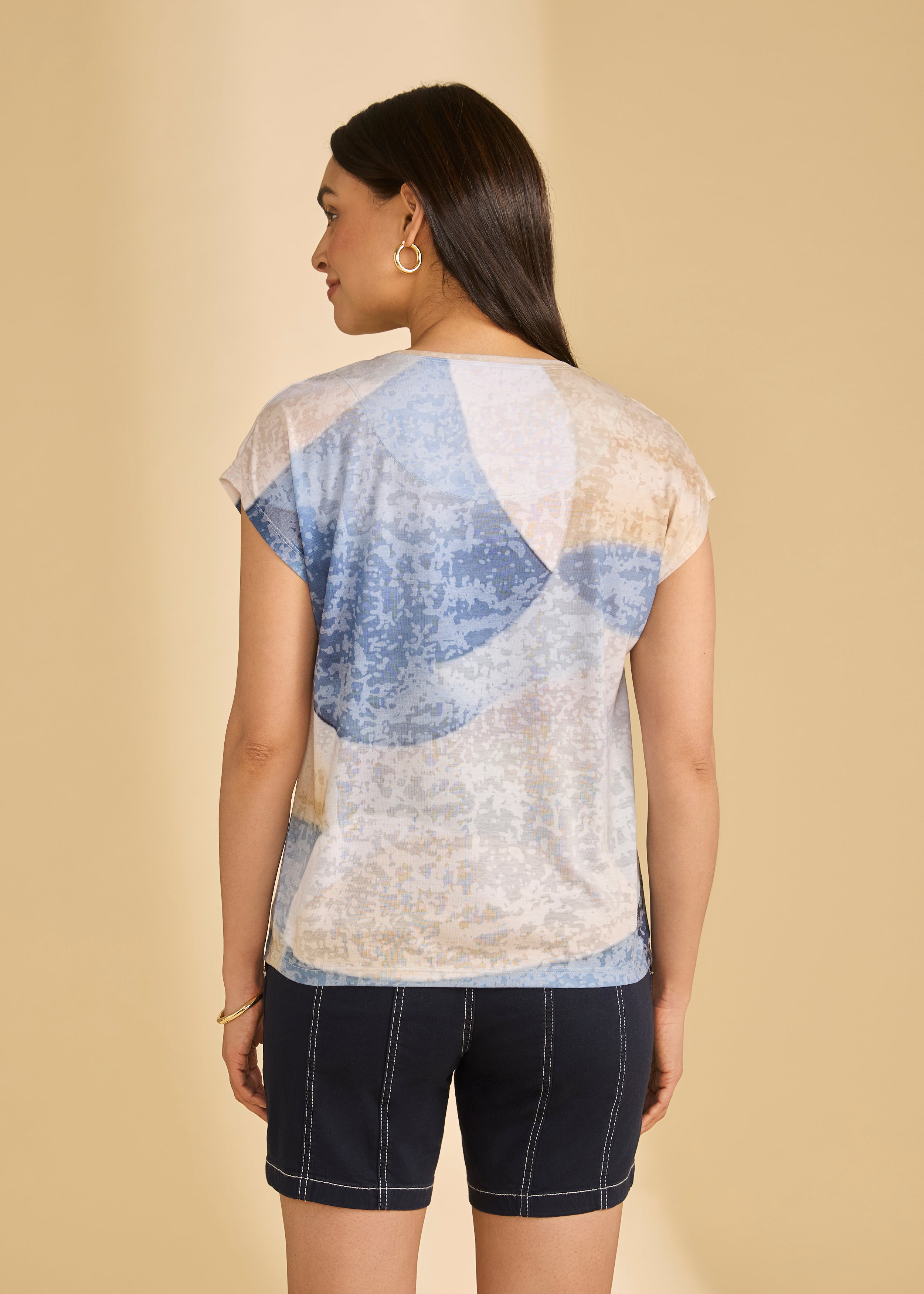 Back view of abstract blue and beige top with navy shorts highlighting casual summer look by French Dressing Jeans (FDJ)