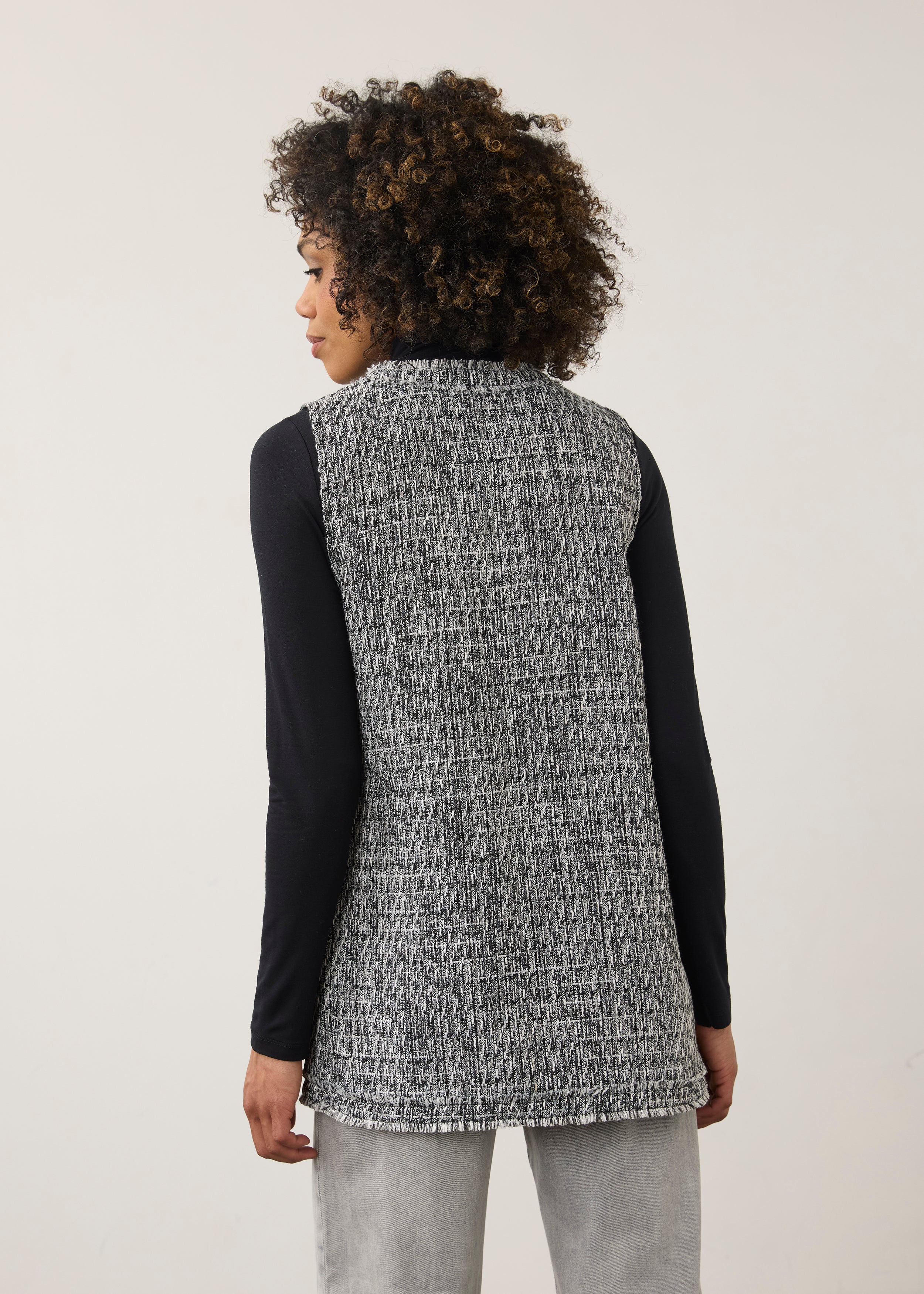 Back view of black and white textured vest featuring a longline silhouette by French Dressing Jeans (FDJ)