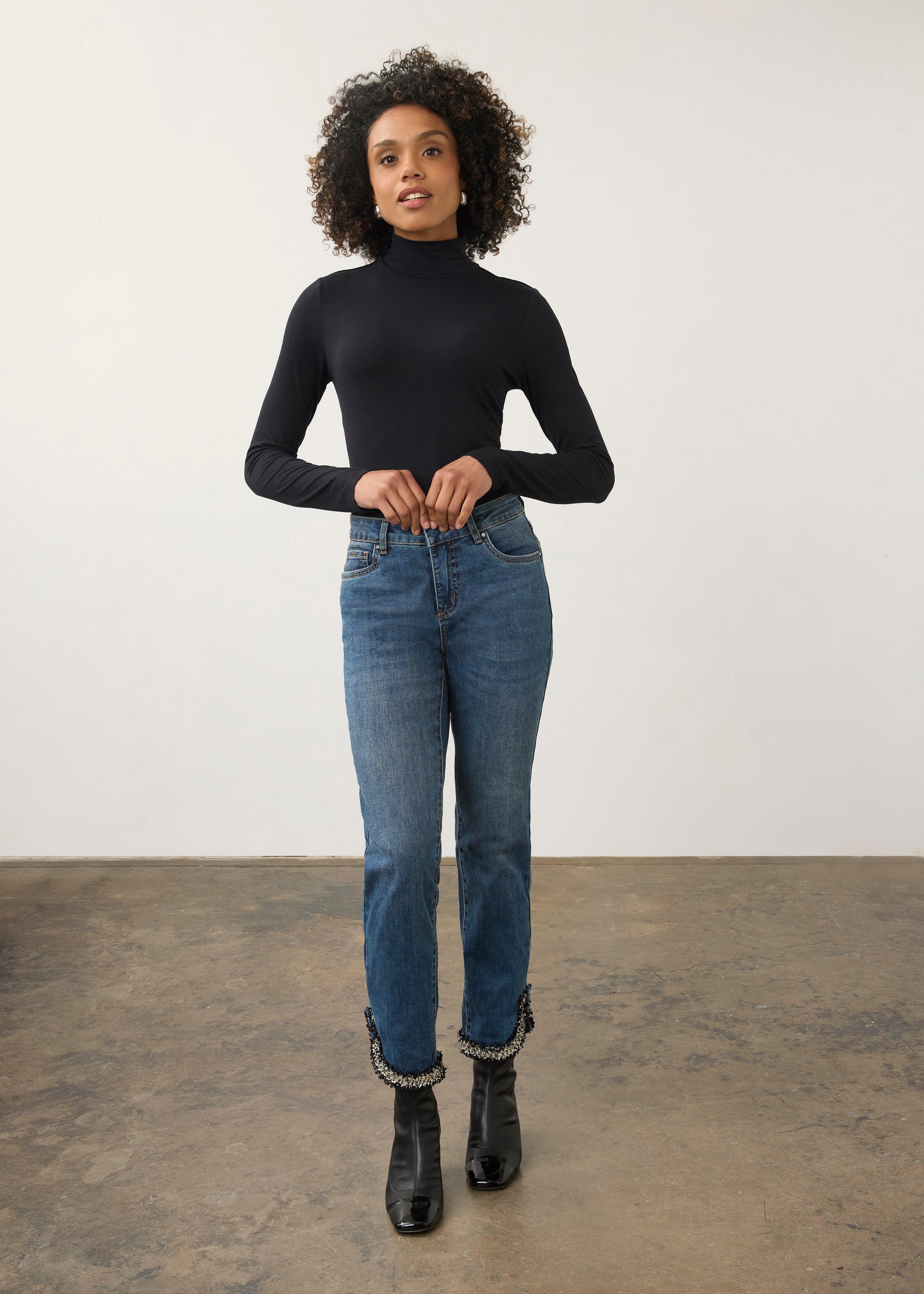 Full body view of black turtleneck top paired with slim-fit jeans by French Dressing Jeans (FDJ)