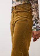 Side detail of brass Olivia denim showing mid-rise waist and slash pockets by French Dressing Jeans (FDJ)
