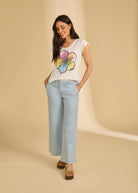 Full outfit view with Rainbow Hibiscus top and light denim jeans, highlighting casual style by French Dressing Jeans (FDJ)