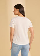 Back view of white V-neck top showcasing pearl-trimmed sleeves by French Dressing Jeans (FDJ)