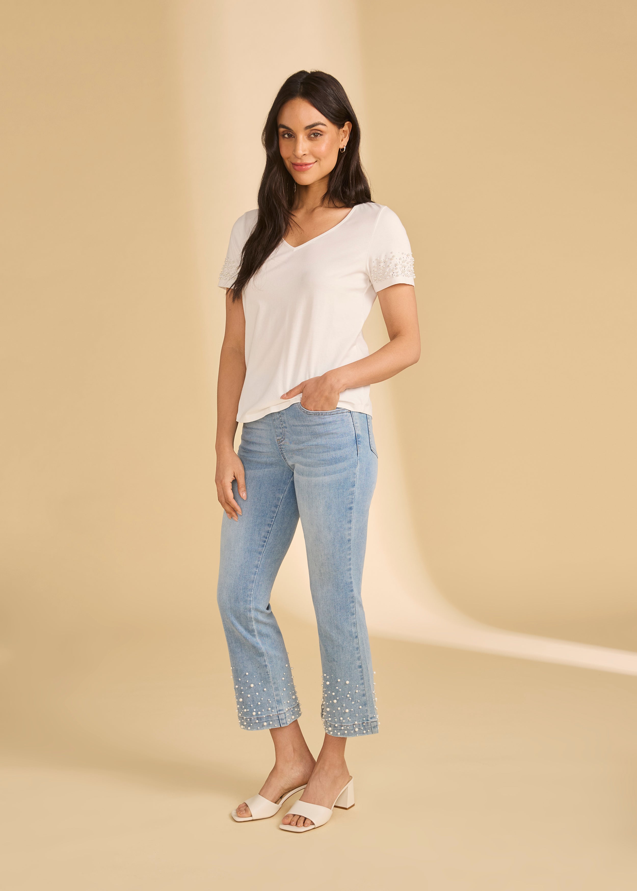 Full body view of white V-neck top paired with light jeans and sandals by French Dressing Jeans (FDJ)