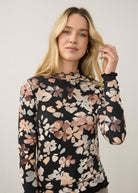 Close-up of floral black top, showcasing detailed pattern and scalloped neckline by French Dressing Jeans (FDJ)