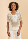 Front view of beige striped V-neck short sleeve top paired with white pants by French Dressing Jeans (FDJ)