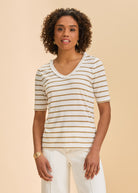 Front view of beige striped V-neck short sleeve top paired with white pants by French Dressing Jeans (FDJ)