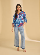 Full view of blue graphic top with flared jeans, casual look by French Dressing Jeans (FDJ)