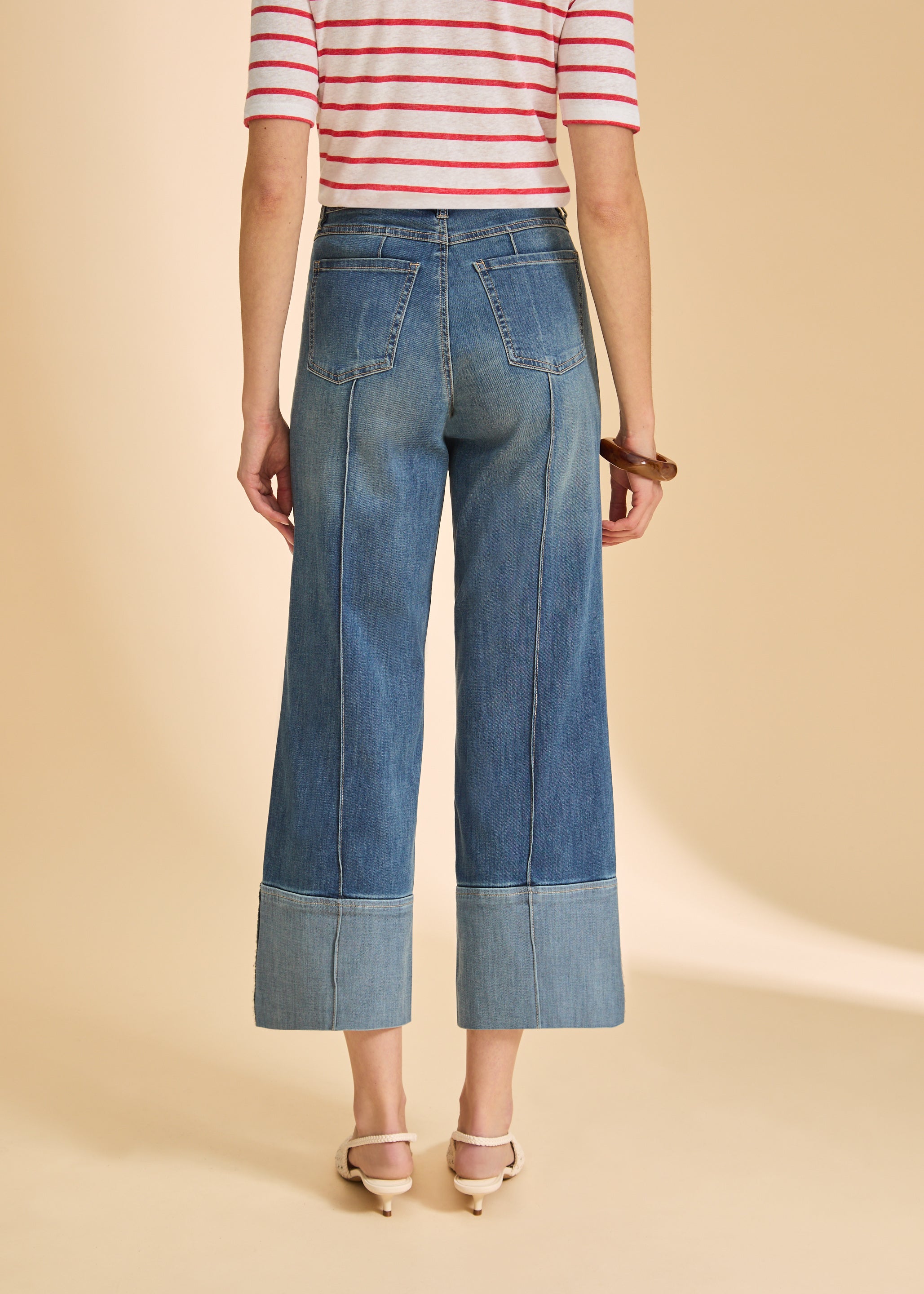 Back view of dark wash wide-leg jeans with cuffed hems and patch pockets by French Dressing Jeans (FDJ)