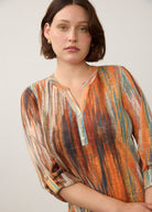 Close-up of Heat Henley top featuring button-front detail and colorful pattern by French Dressing Jeans (FDJ)
