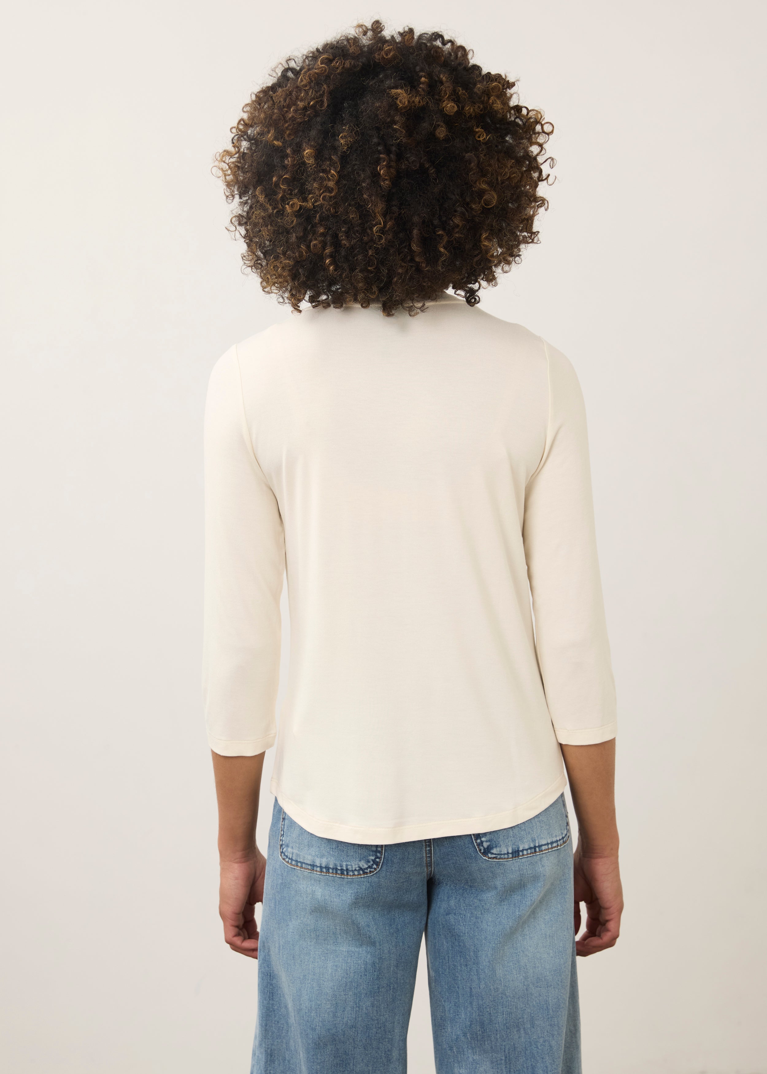 Back view of cream V-neck top highlighting seamless design and smooth material by French Dressing Jeans (FDJ)