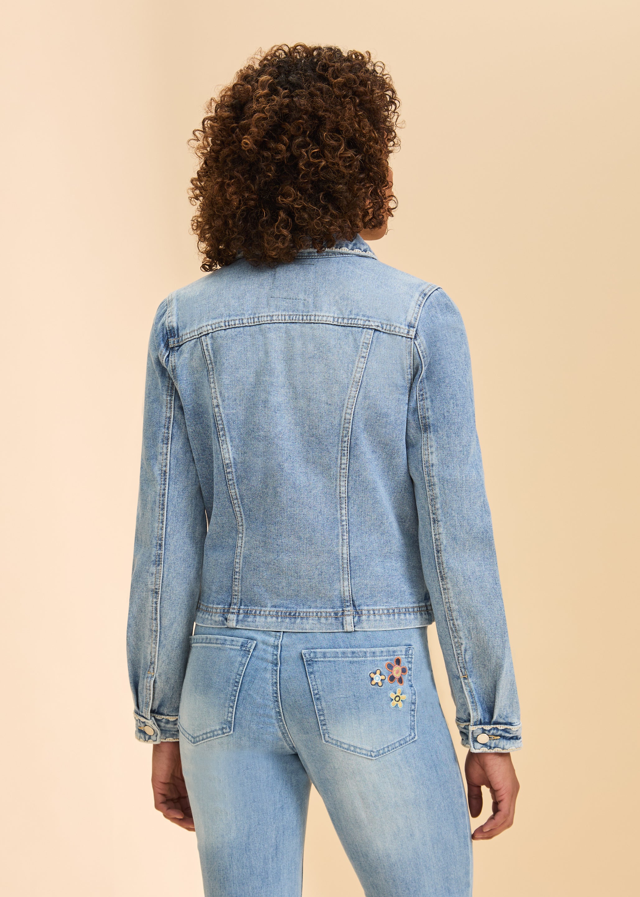 Back view of pale wash denim jacket highlighting seam details and long sleeves by French Dressing Jeans (FDJ)