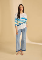 Full-body view of light metallic lime trousers with abstract patterned top by French Dressing Jeans (FDJ)