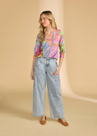 Full body view of neon palm top paired with wide-leg jeans, showcasing casual style by French Dressing Jeans (FDJ)