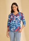 Front view of blue graphic V-neck top with bold star patterns by French Dressing Jeans (FDJ)