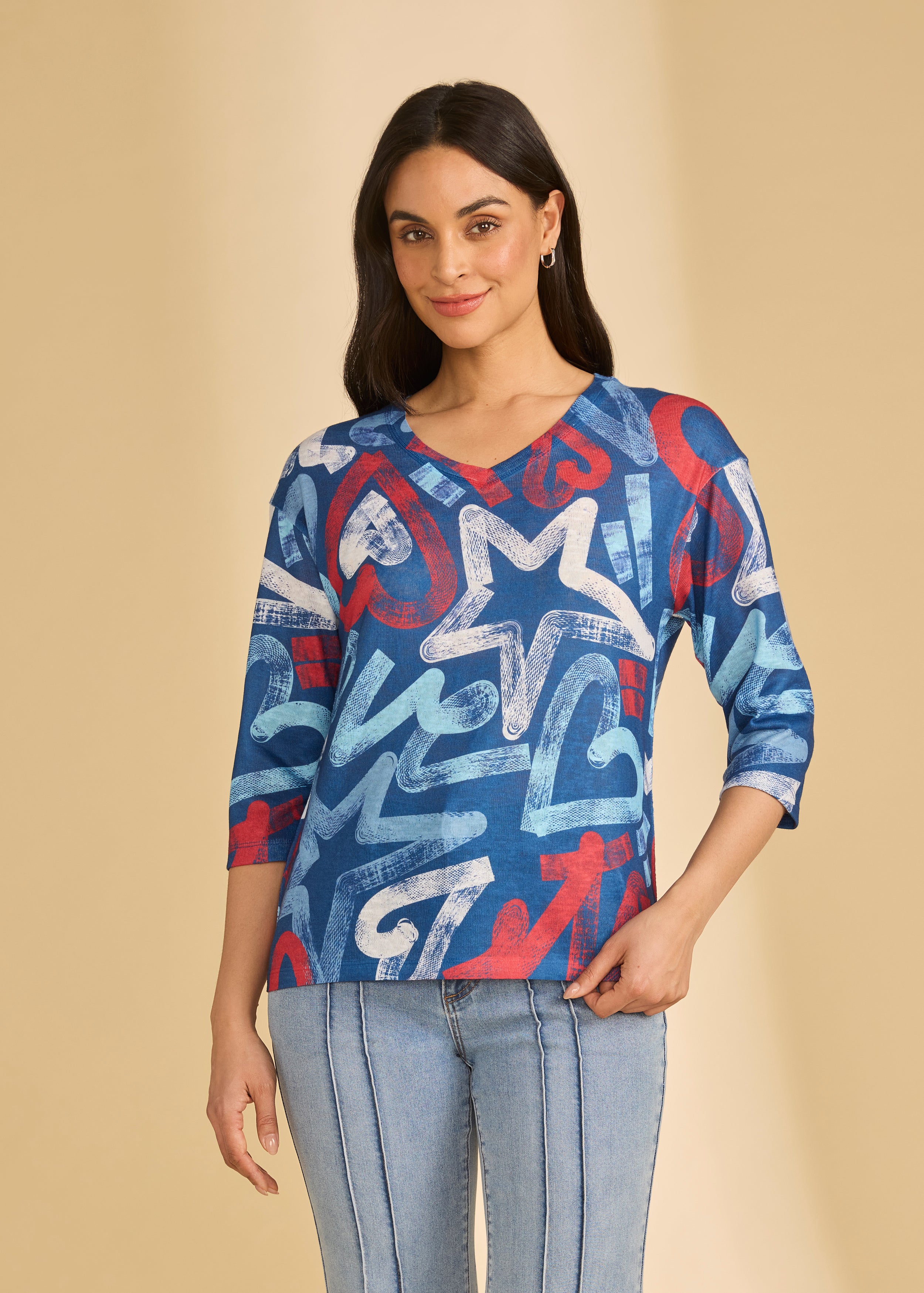 Front view of blue graphic V-neck top with bold star patterns by French Dressing Jeans (FDJ)